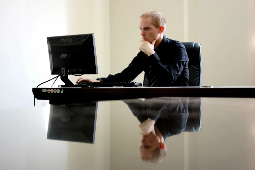 an image of a lawyer sitting at a desk, surrounded by legal documents and charts